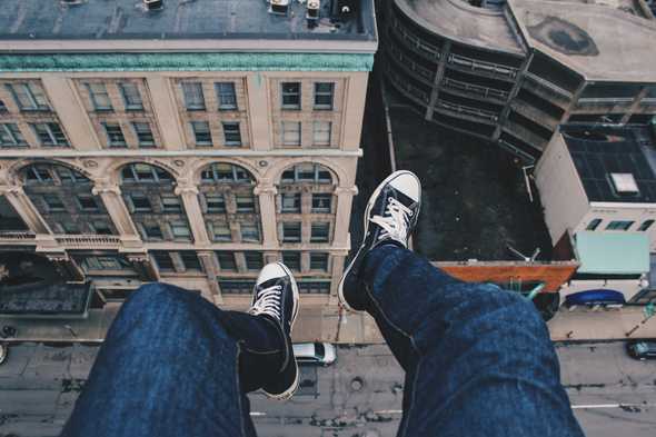 Feet dangling from roof